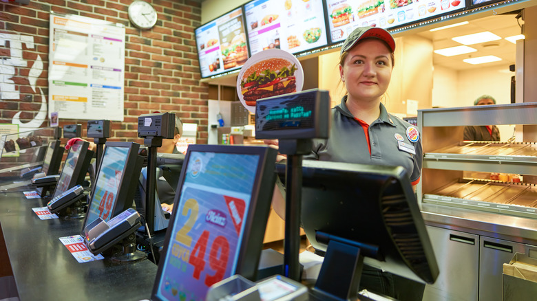 Burger king cashier behind counter