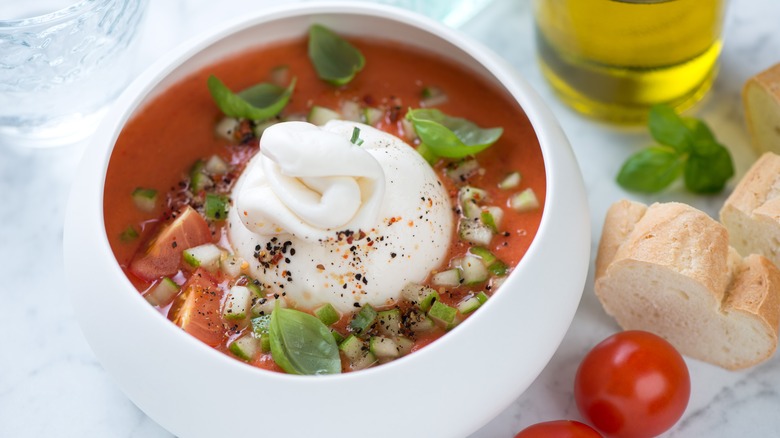 bowl of tomato soup with burrata cheese