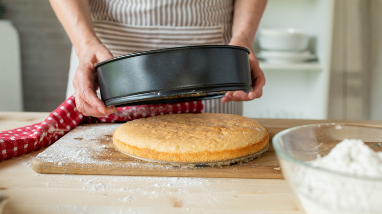 Cake on cutting board being released from pan