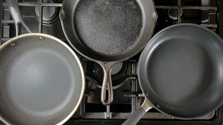 Three pans on a gas stovetop