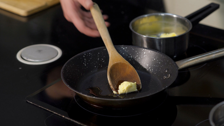 chef melting butter in pan