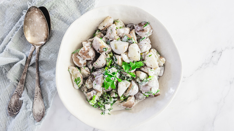 Potato salad with napkin and two spoons