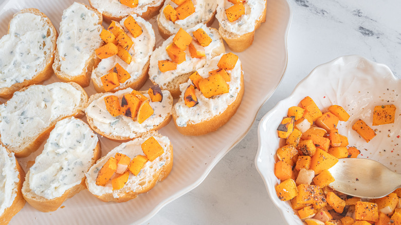 scooping butternut squash on bruschetta