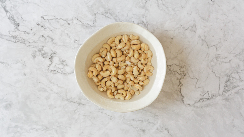 Cashews soaking in a white bowl