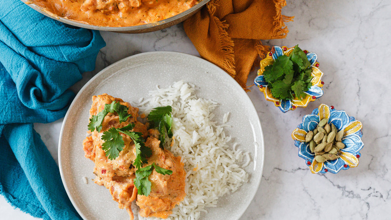 Kofta on white plate with rice and herbs