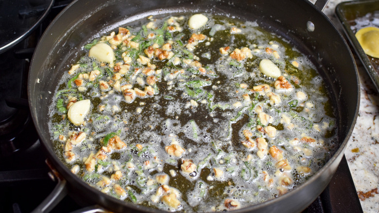 garlic and herbs cooking in pan