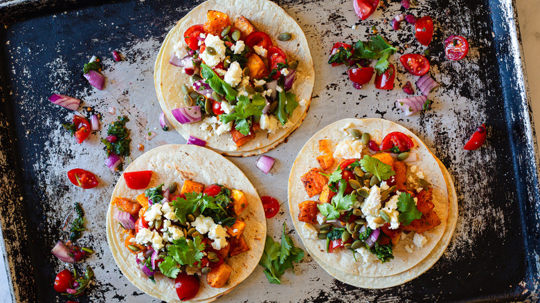 three tacos on baking sheet