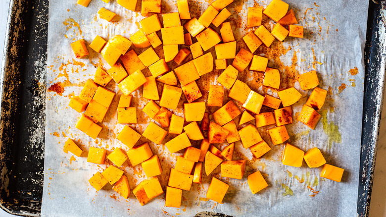 cubed seasoned squash on baking sheet