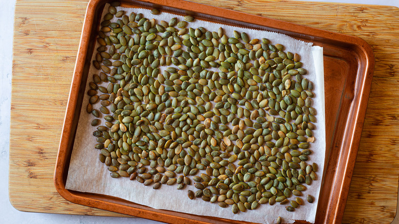 pumpkin seeds on baking sheet