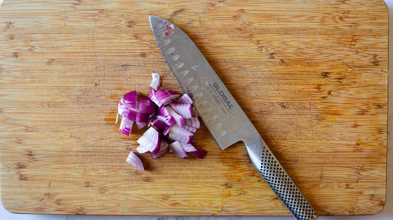 Onion and knife on cutting board