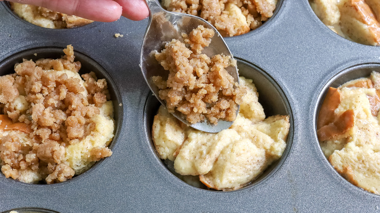 sprinkling topping on muffins