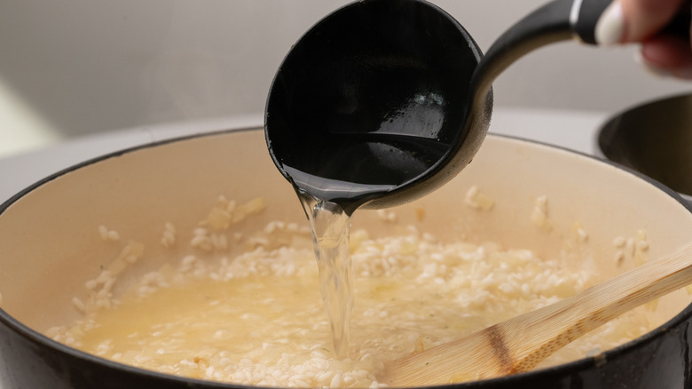 ladling stock into risotto