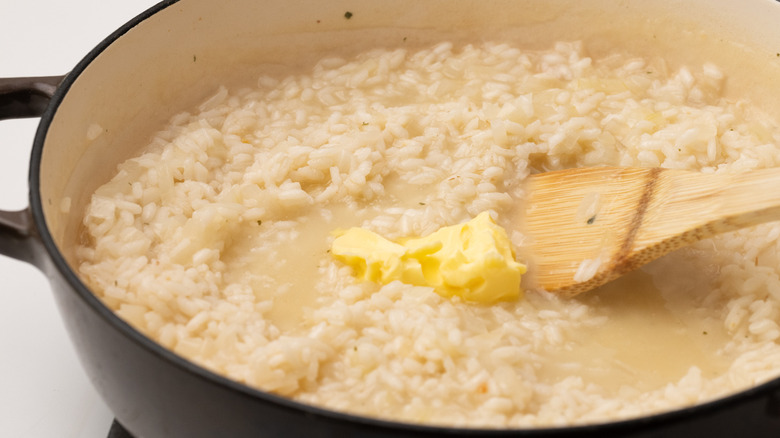 stirring butter into risotto