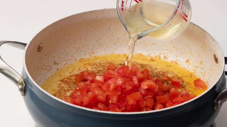 Pouring wine into pan