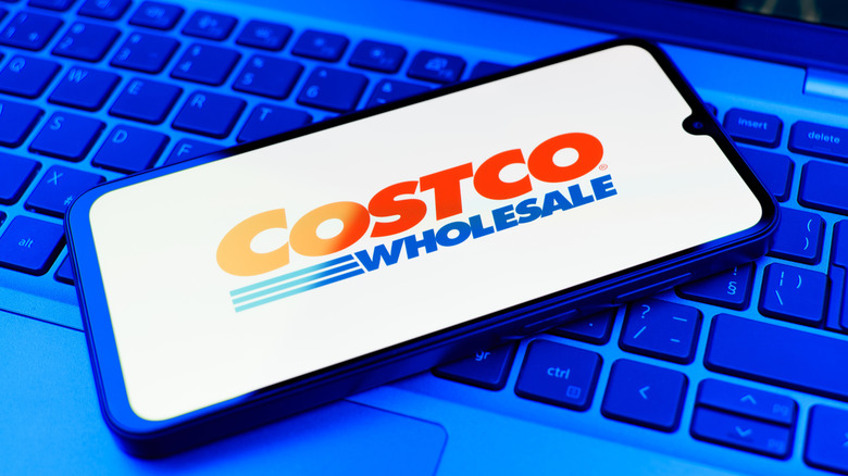 Smartphone with Costco app on a keyboard