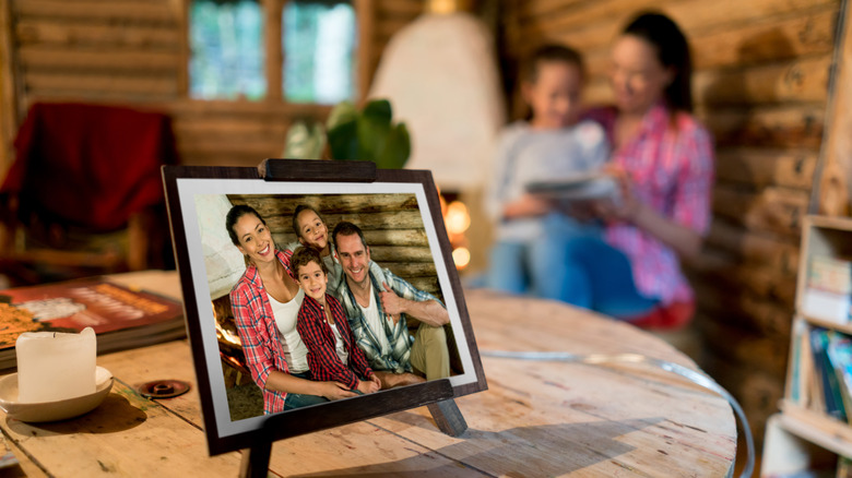 Framed photo of family on a table with blurred people in background