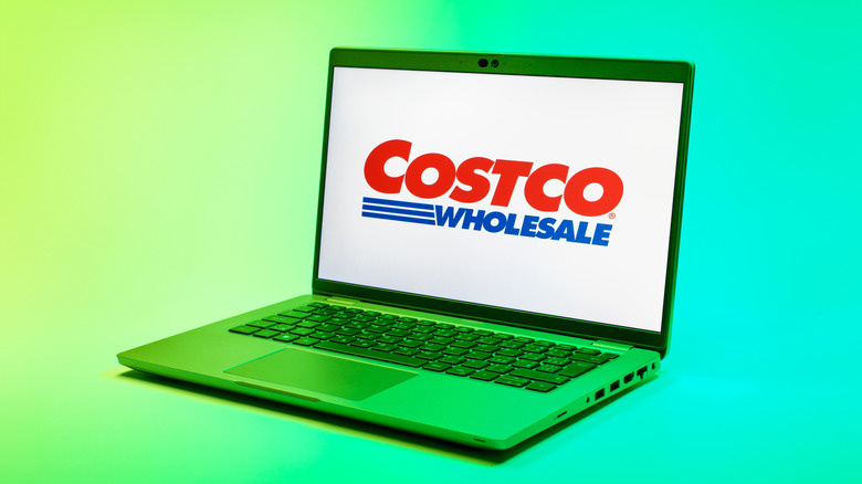 Costco logo on a laptop screen against green and yellow background