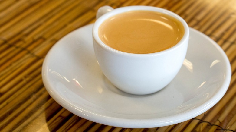 A café Cubano in a white mug on a saucer