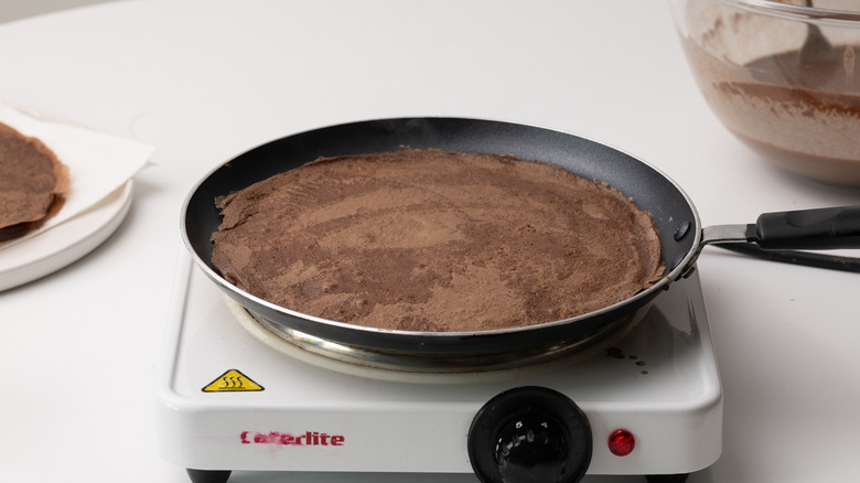 chocolate crepe cooking in pan