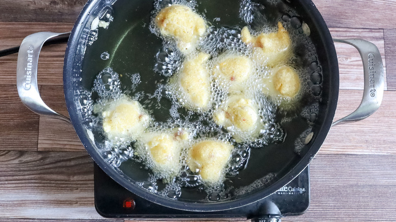 hush puppies frying in pot