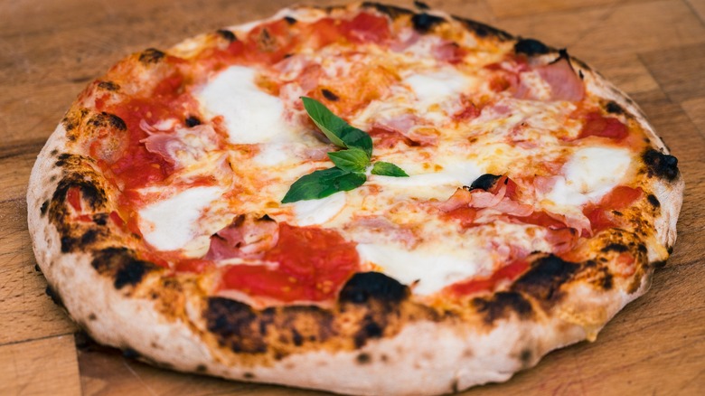 Rustic Napoletana pizza with tomatoes and fresh mozzarella cheese