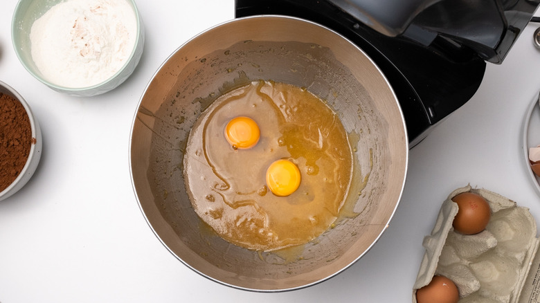 adding eggs to brownie batter