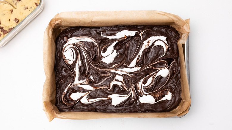 swirling marshmallow fluff through brownies