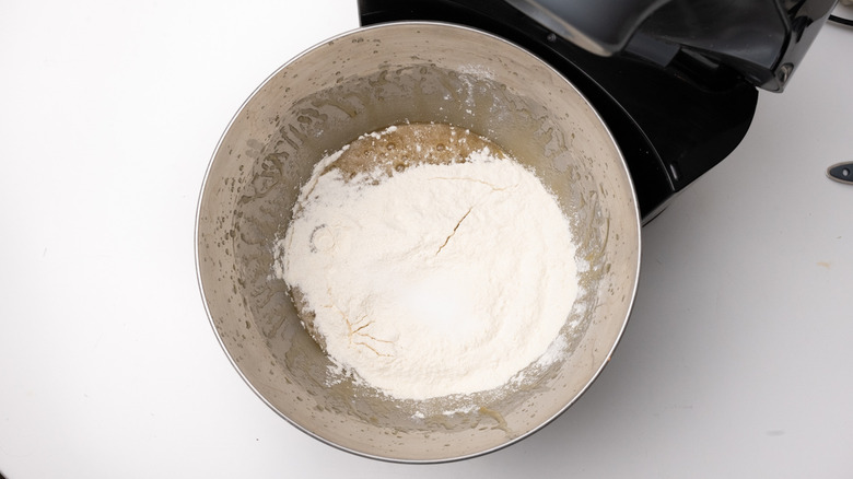 adding flour to cookie dough