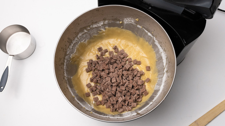 adding chocolate to cookie dough