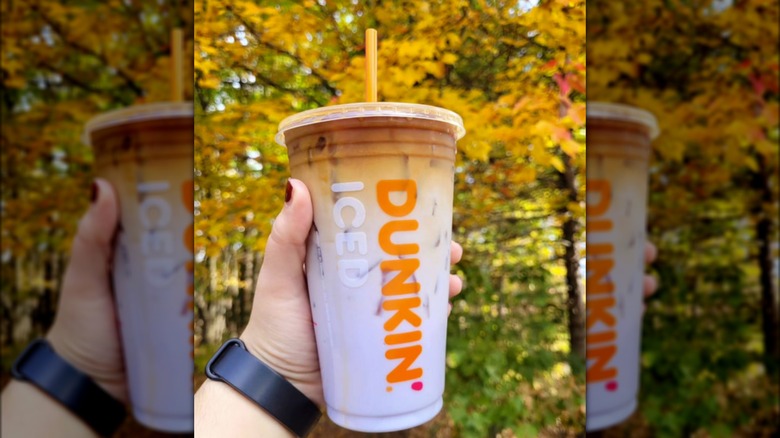 Dunkin Potion Macchiato in front of fall leaves