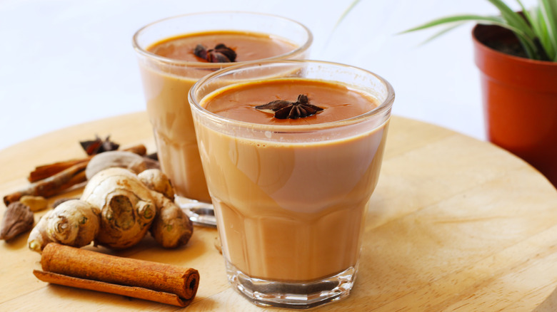 Two glasses of chai with ginger and star anise