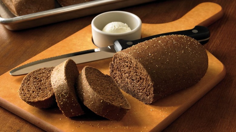 wooden tray with loaf of bread and side of butter at Outback SteakHouse