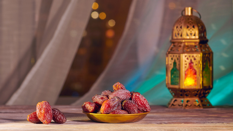 Bowl of dates, eaten to break the ramadan fast, beside lantern