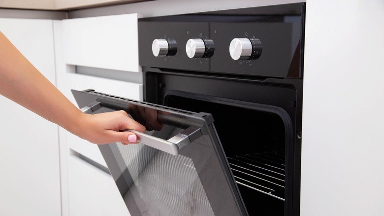 Person opening oven door