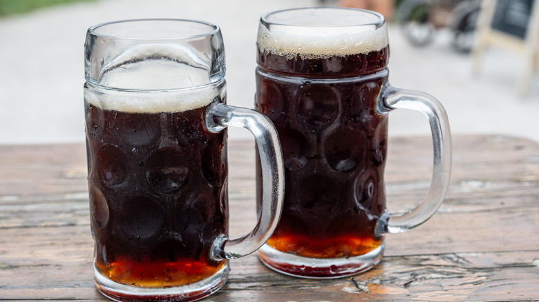 Two pints of Doppelbock resting on a picnic table