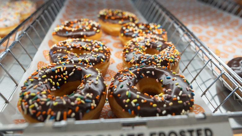 chocolate frosted Dunkin' donuts on display in store