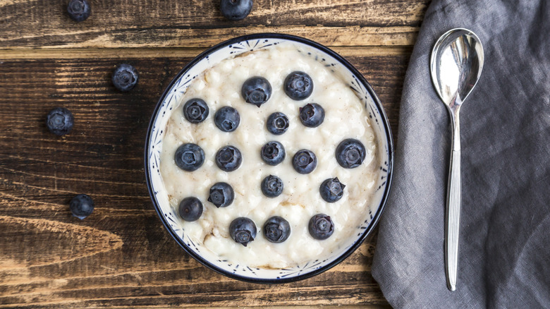 a bowl of rice pudding with blueberries