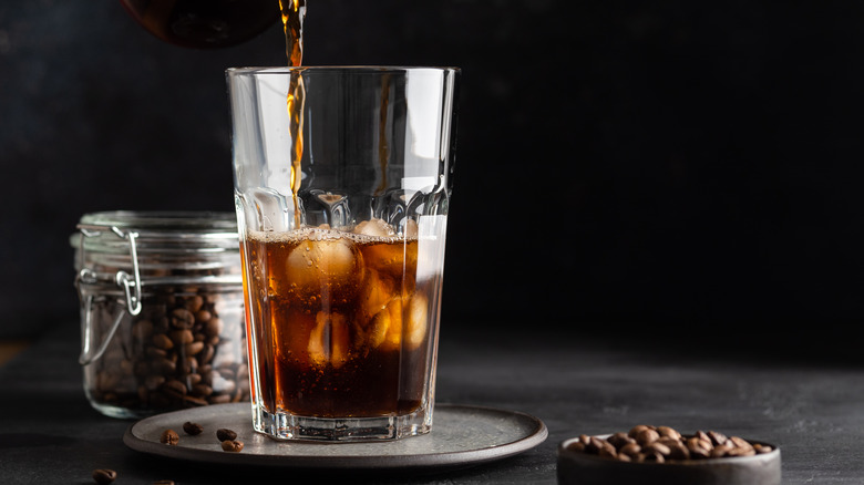 Pouring cold brew coffee over ice