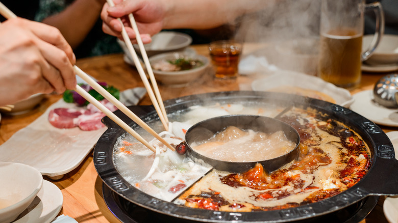 eating hot pot with chopsticks