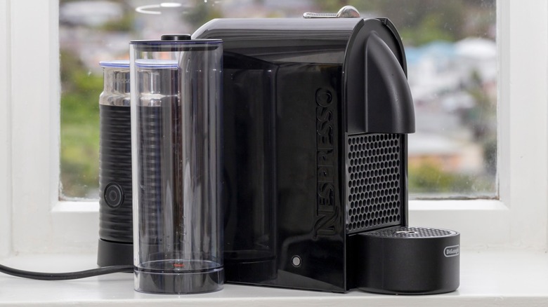 A Nespresso machine in front of a window