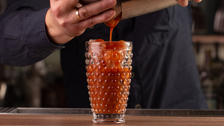 Pouring a Caesar into a glass