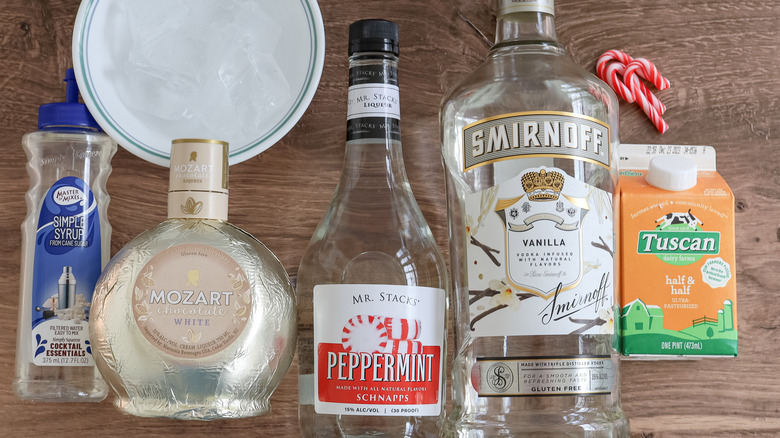 candy cane martini ingredients on wooden table