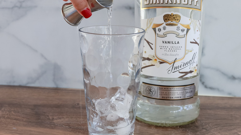 pouring vanilla vodka into glass