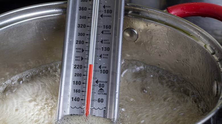 candy thermometer in boiling pot