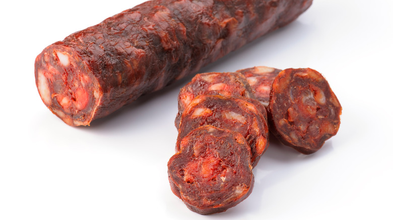 iberian sausage chorizo cut isolated on white