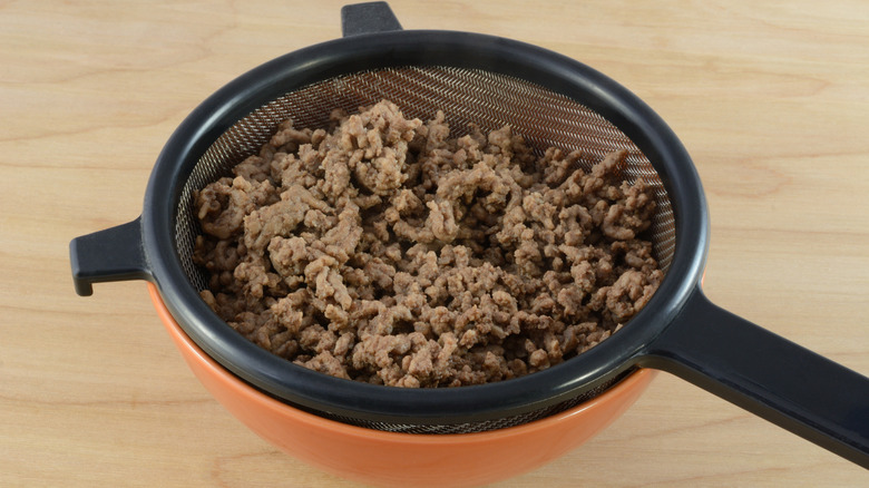 cooked ground beef in a strainer