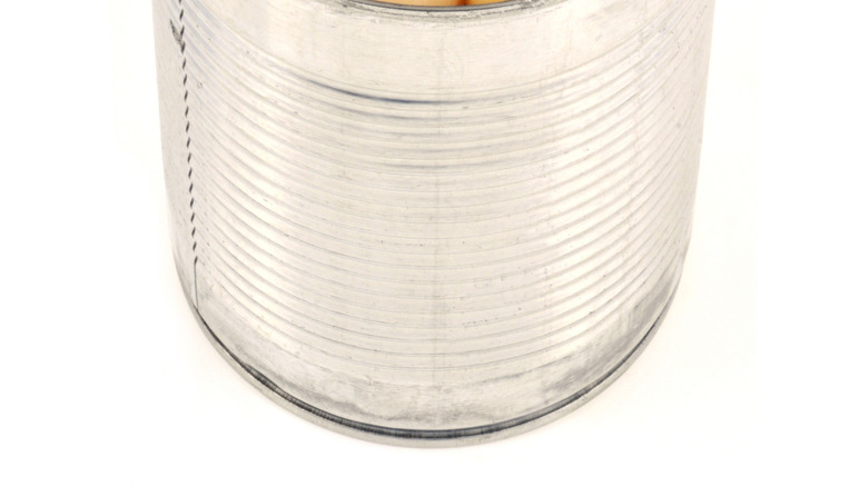 canned potatoes peeled in a tin can on a white background