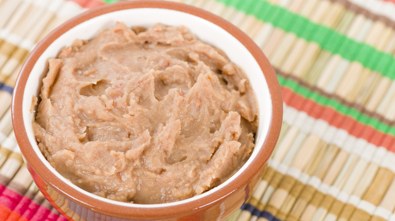 bowl refried beans on a colorful background