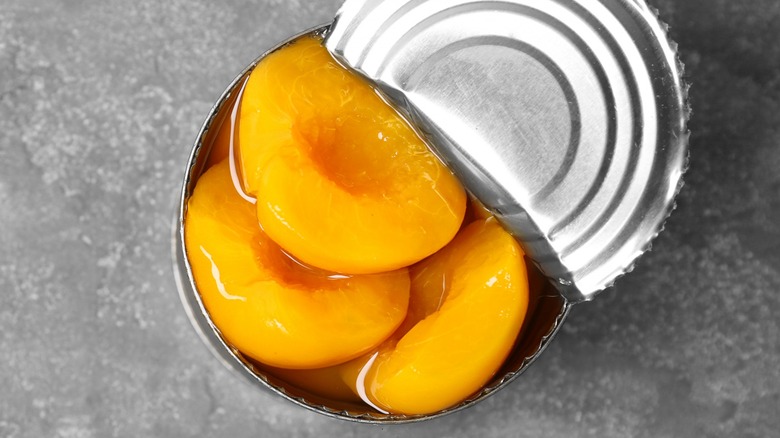 Top-down view of an opened can of preserved peaches