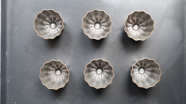 cannelé molds on baking sheet